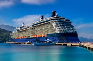 image of the Celebrity Silhouette cruise ship docked at a port featuring the turquoise waters 