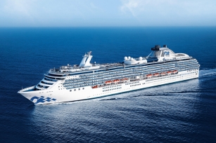 Aerial view of the Coral Princess cruise ship gliding through the deep blue seas 