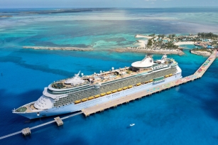 Aerial view of the Freedom of the Seas cruise ship docked at a port of call with its turquoise waters