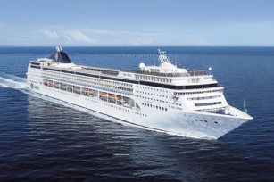 image of MSC Opera from the side point of view featuring calm waters and blue skies