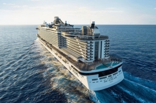 close up of the back of the MSC Seascape cruise ship gliding through the blue waters against the blue skies in the background